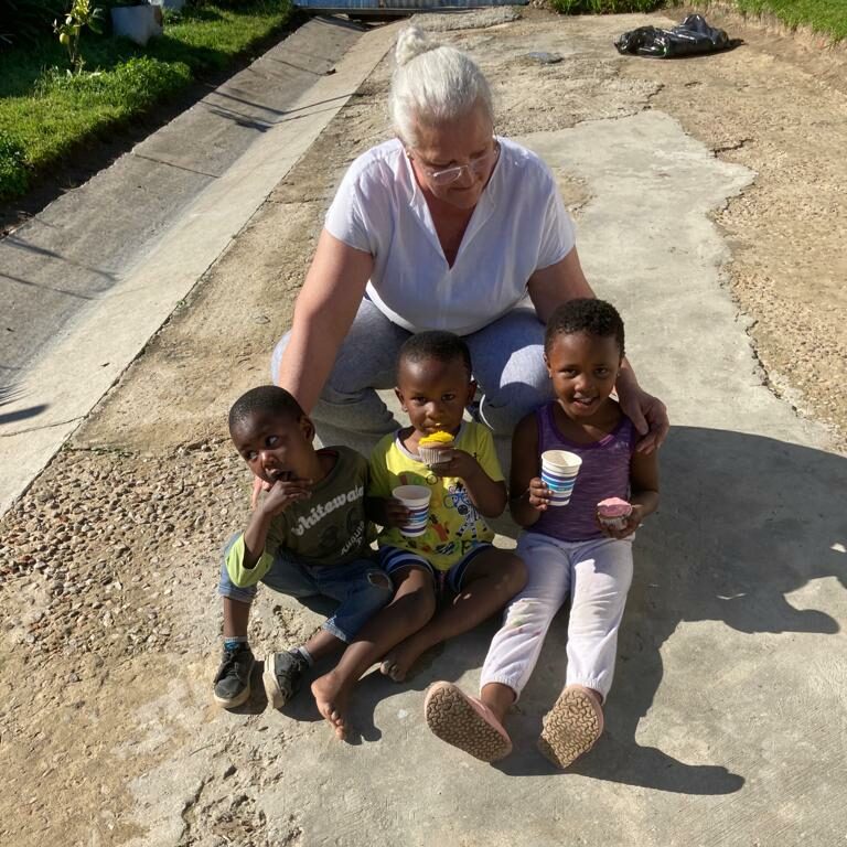 together we serve_Linda feeding kids