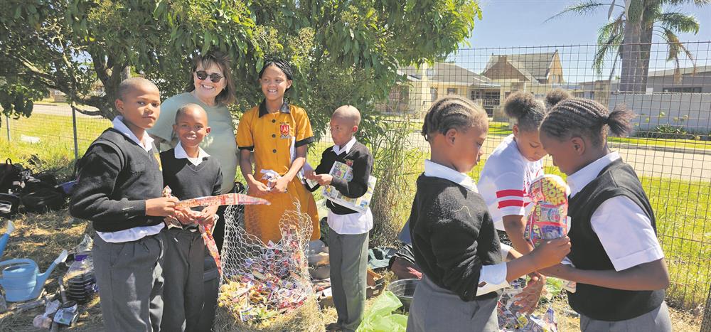 Usapho Indlu CEO Sally Versfeld with learners adding ingredients to their compost heaps. From left are T-J James, Johnwin Booysen, Tashlee-ann Titus, Chivargo van Dervint, Ronell Frans, Animicka Vass and Angelique Jacobs.