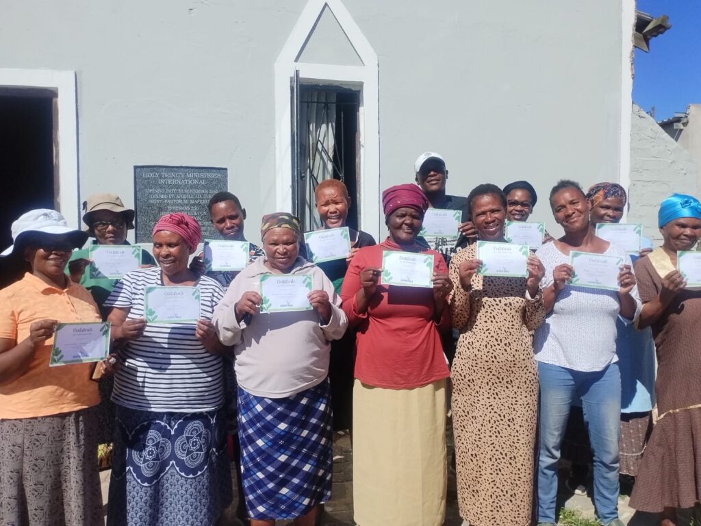 Women showing certificates for a course they completed.